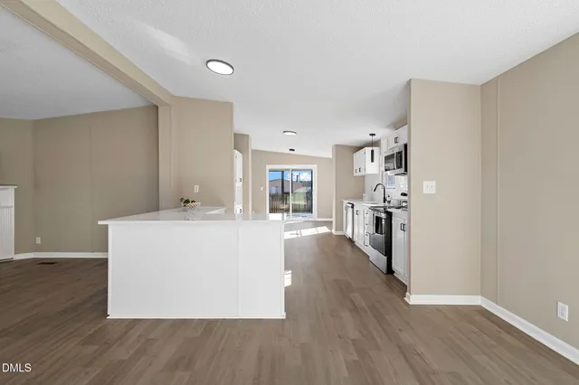 a view of a livingroom with furniture hardwood floor and a ceiling fan