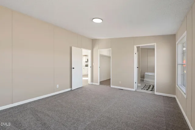 a view of a kitchen with refrigerator and wooden floor
