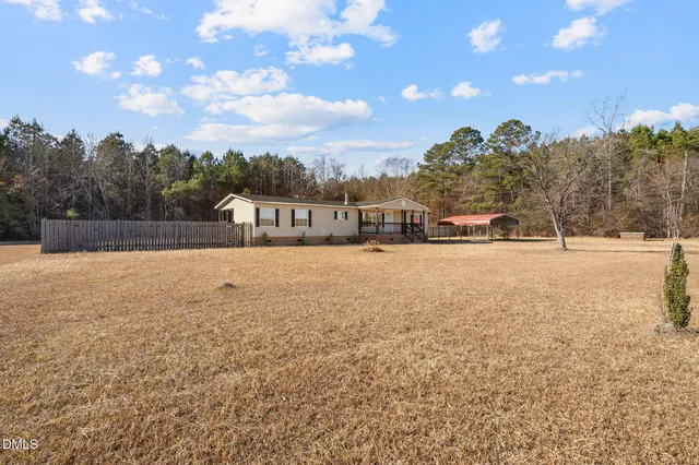 a view of residential houses with yard and mountain view in back