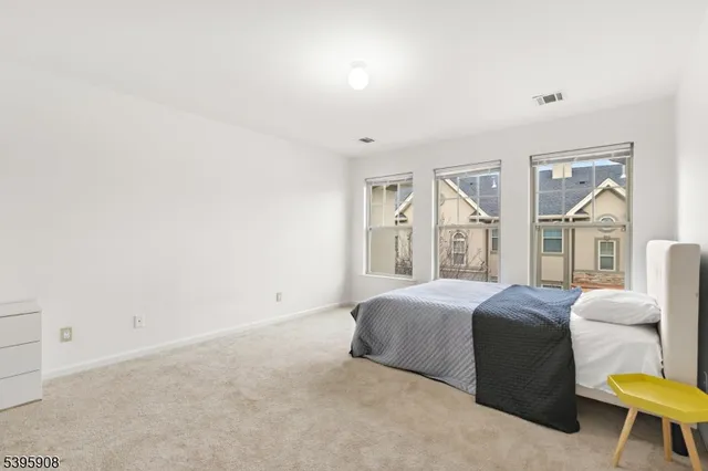 a spacious bedroom with a bed and a couch