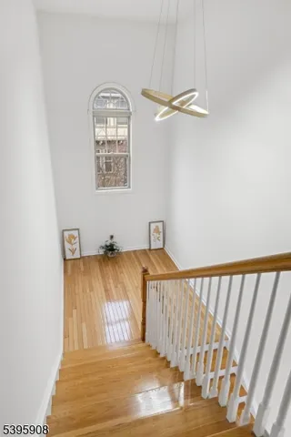 a view of a bedroom with wooden floor and a window