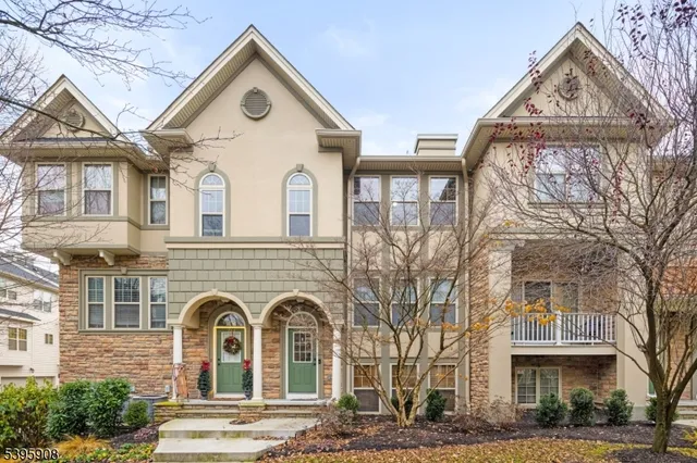 a view of a white house with a outdoor space and a tree
