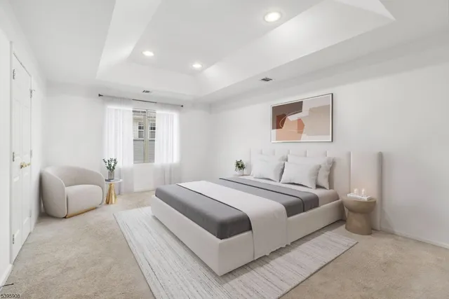 a spacious bedroom with a bed and a couch