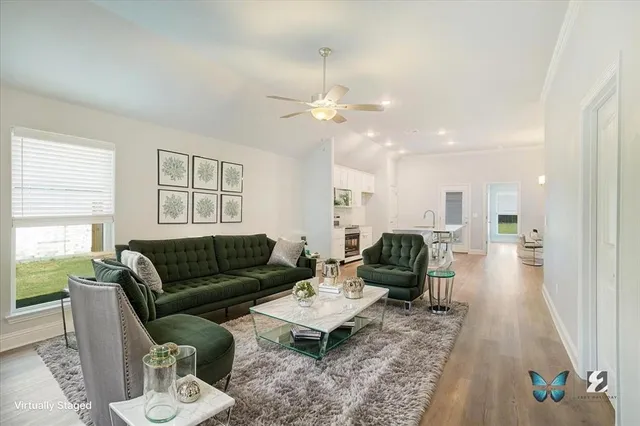 a view of a house with wooden floor and a kitchen view