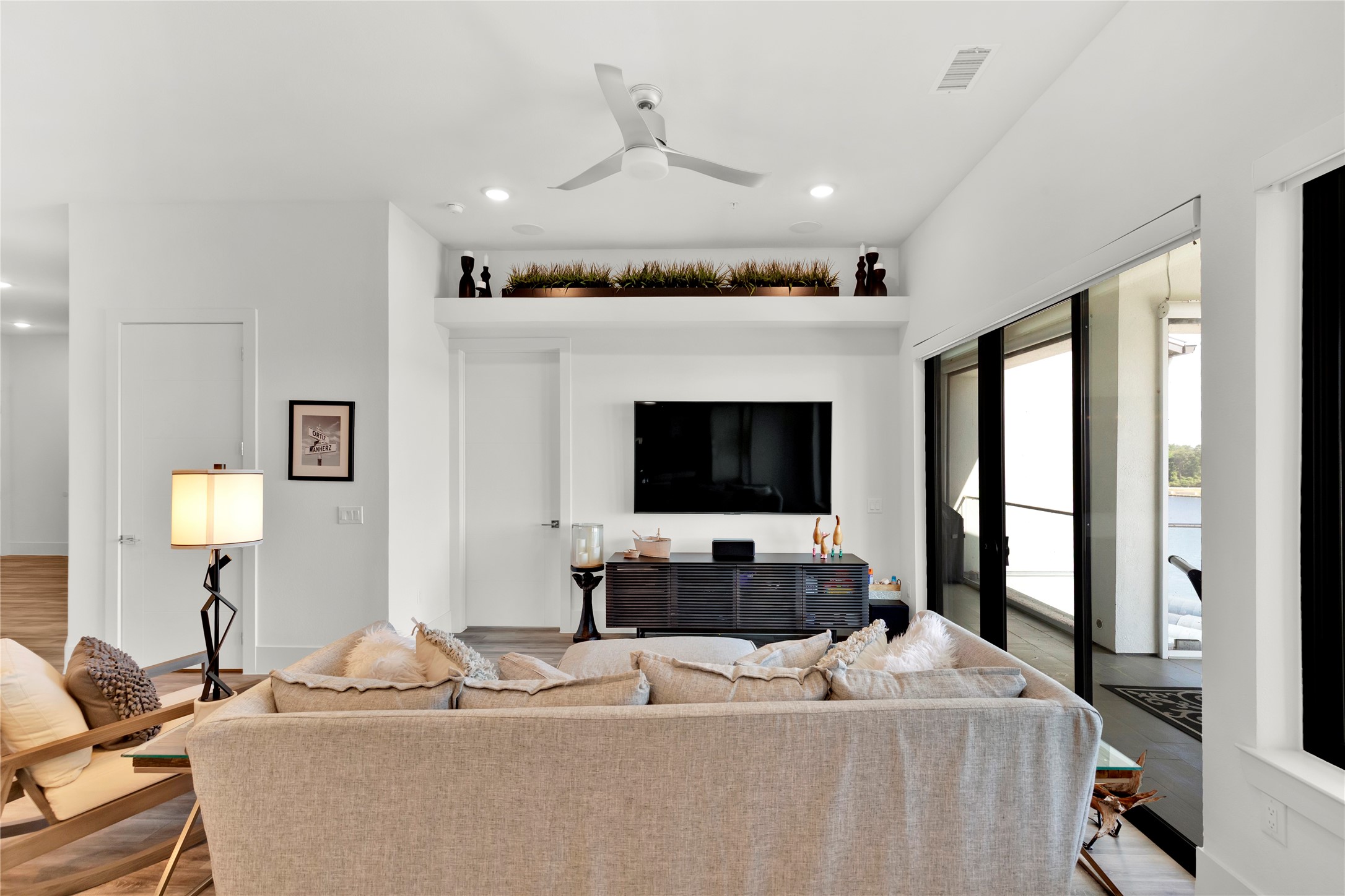 199 Waterpoint Court, Unit 412 Conroe, TX 77304 - Photo 11 of 29 a living room with furniture and a flat screen tv