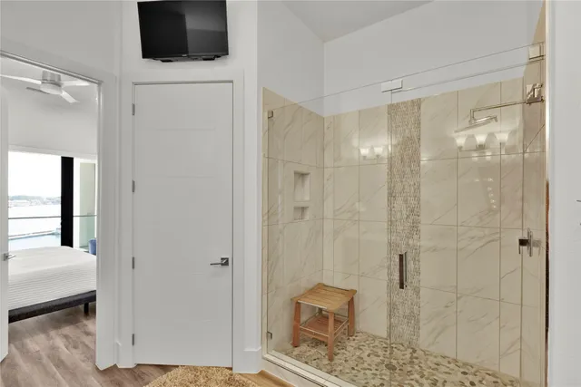 a bathroom with a shower and a mirror