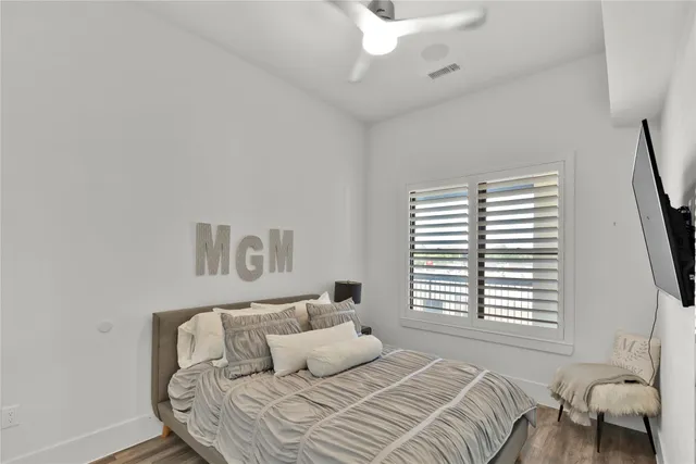 a bedroom with a bed and a large window