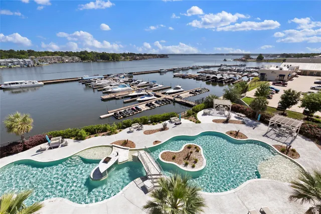 an aerial view of a house with a swimming pool patio and outdoor seating