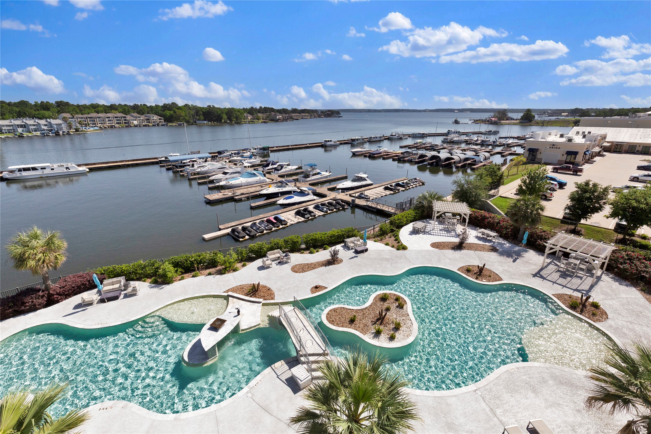 199 Waterpoint Court, Unit 412 Conroe, TX 77304 - Photo 2 of 29 an aerial view of a house with a swimming pool patio and outdoor seating