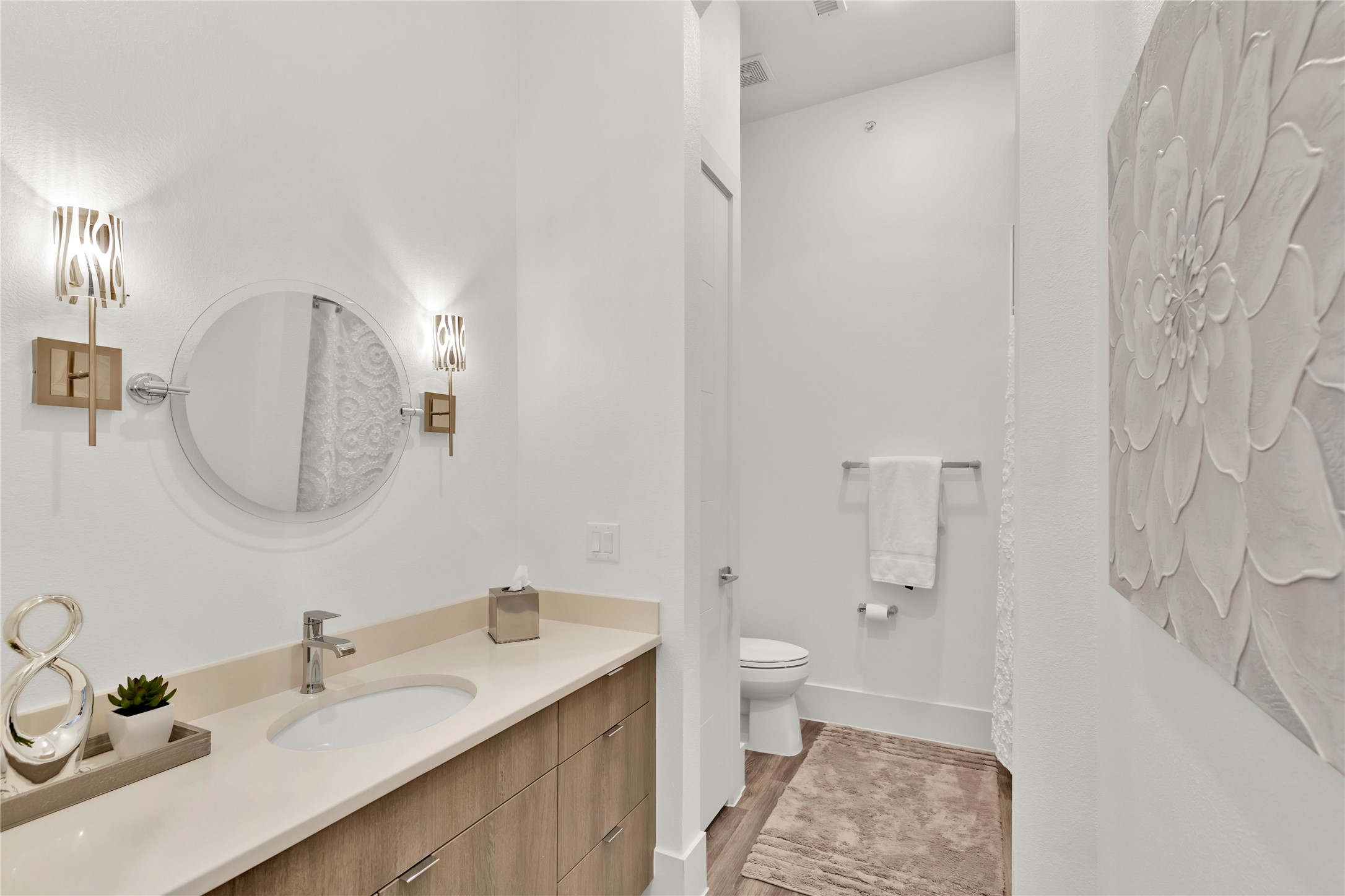 199 Waterpoint Court, Unit 412 Conroe, TX 77304 - Photo 21 of 29 a bathroom with a sink a toilet and a mirror