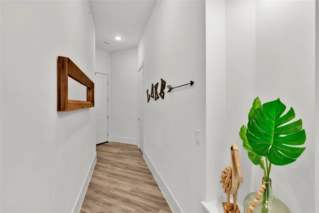 a view of a hallway with wooden floor
