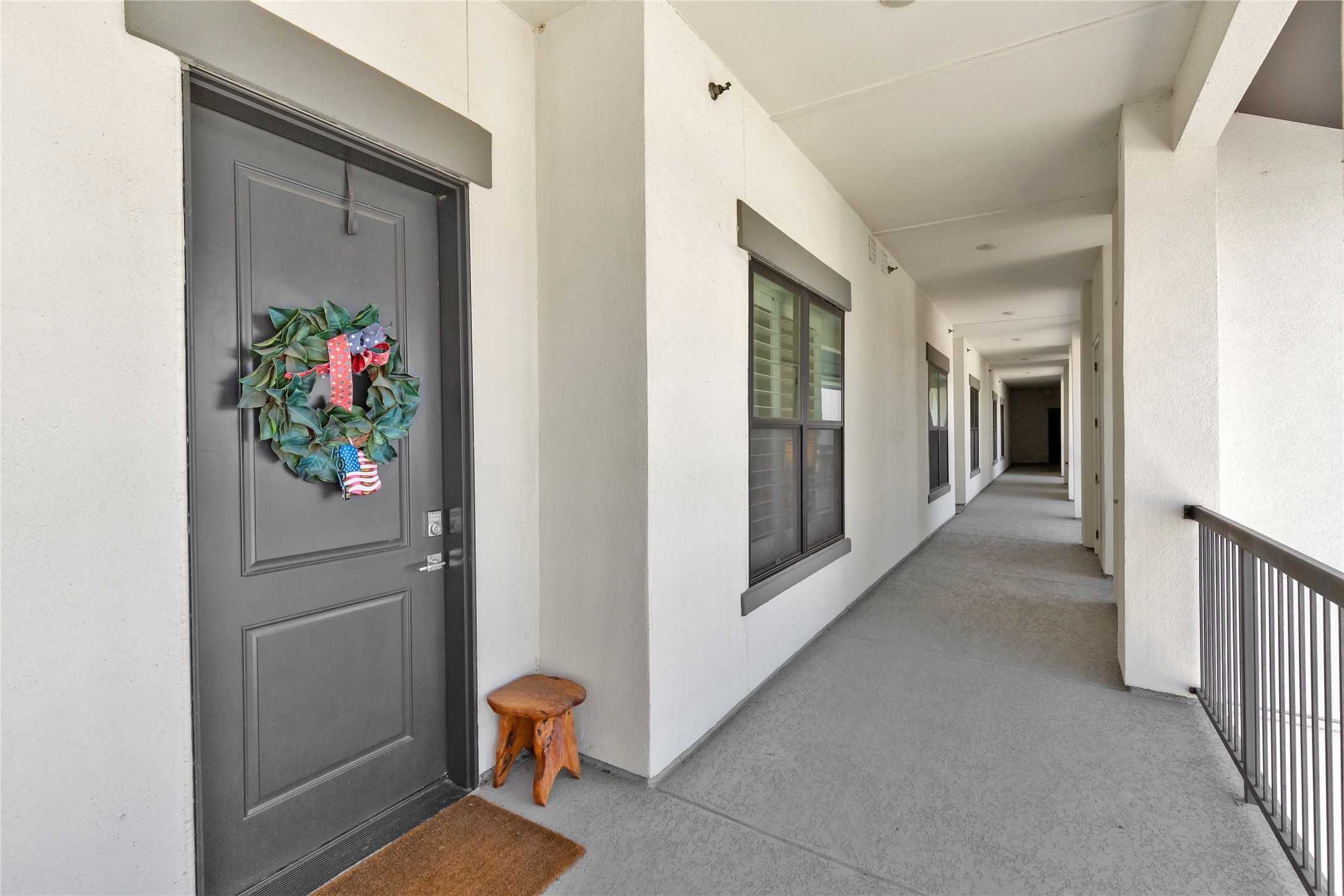 199 Waterpoint Court, Unit 412 Conroe, TX 77304 - Photo 25 of 29 a view of a hallway with wooden floor and dining room