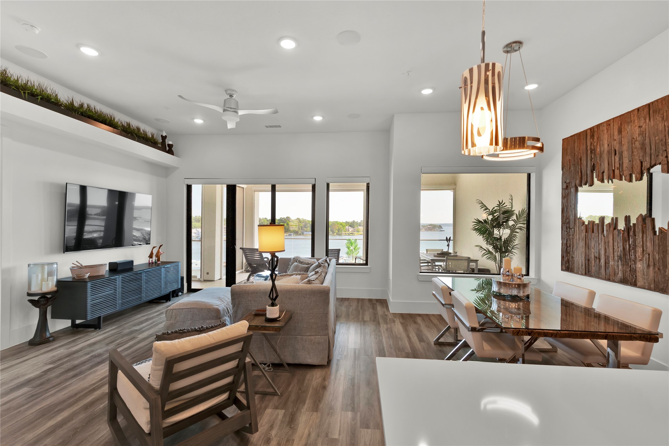 199 Waterpoint Court, Unit 412 Conroe, TX 77304 - Photo 5 of 29 a living room with furniture a flat screen tv and a large window