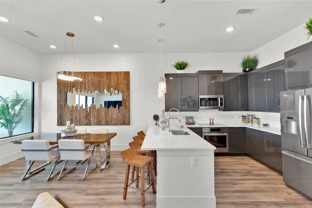 a large kitchen with a table and chairs in it