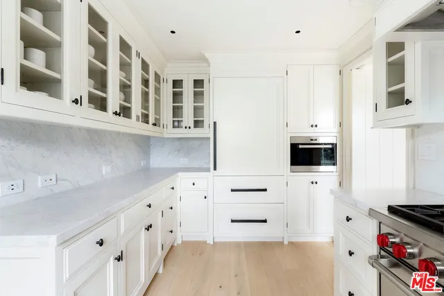 a kitchen with cabinets and appliances