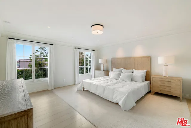 a bedroom with a bed and glass window