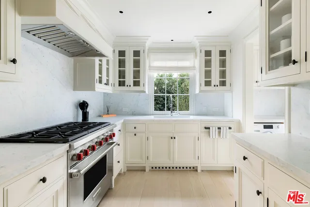 a kitchen with granite countertop a stove and a sink