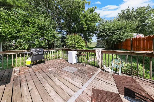 a balcony with wooden floor and fence