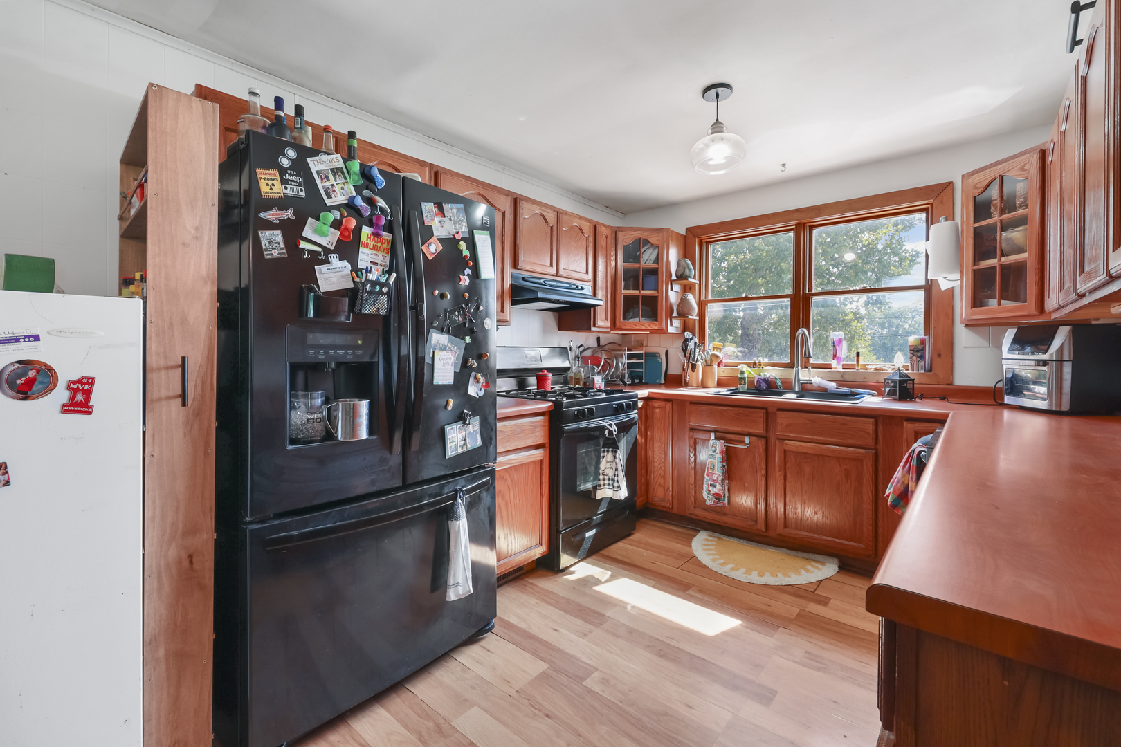 180 Highway 6 Morris, IL 60450 - Photo 5 of 18 a kitchen with stainless steel appliances granite countertop a refrigerator a sink dishwasher a stove and a dining table with wooden floor