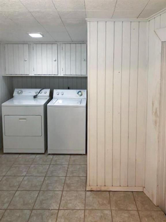 602 West 3rd Street Justin, TX 76247 - Photo 18 of 22 Dedicated laundry area featuring a tile floor, white vertical paneling, and upper cabinetry