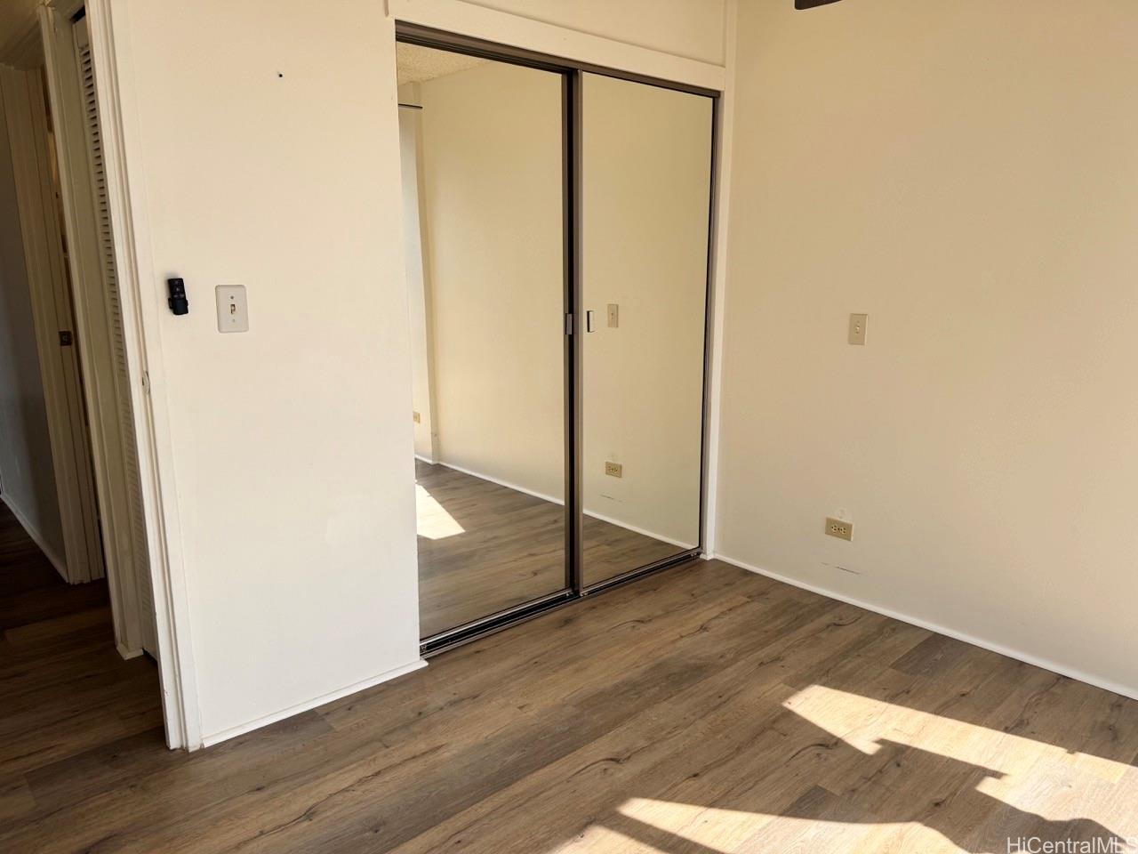 3130 Ala Ilima Street, Unit 22A Honolulu, HI 96818 - Photo 16 of 19 an empty room with wooden floor and entrance