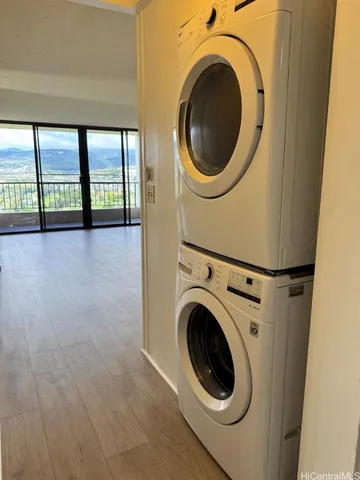 a view of a hallway with washer and dryer