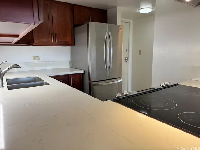 a kitchen with a refrigerator and a sink