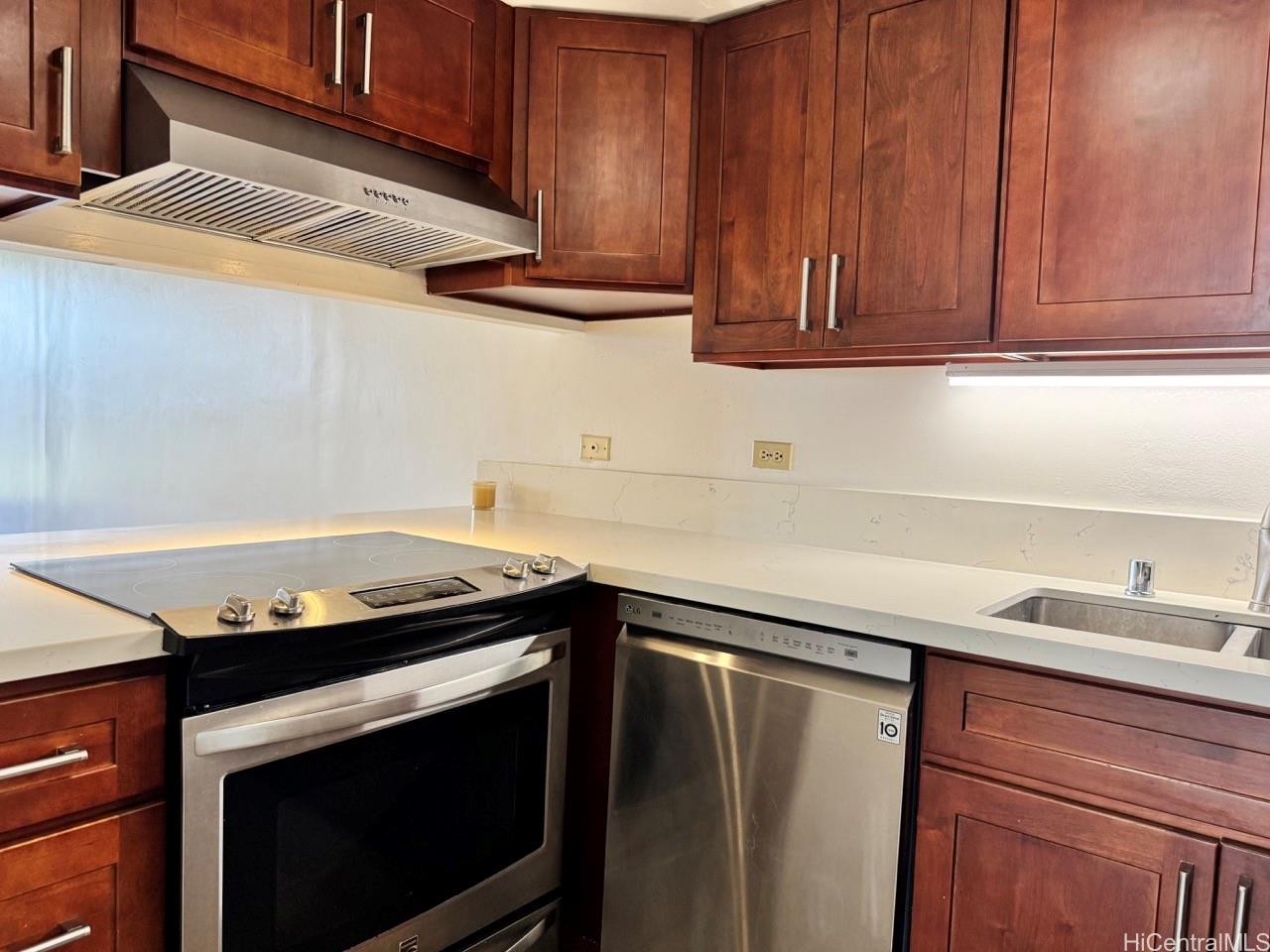 3130 Ala Ilima Street, Unit 22A Honolulu, HI 96818 - Photo 5 of 19 a kitchen with granite countertop cabinets stove top oven and microwave