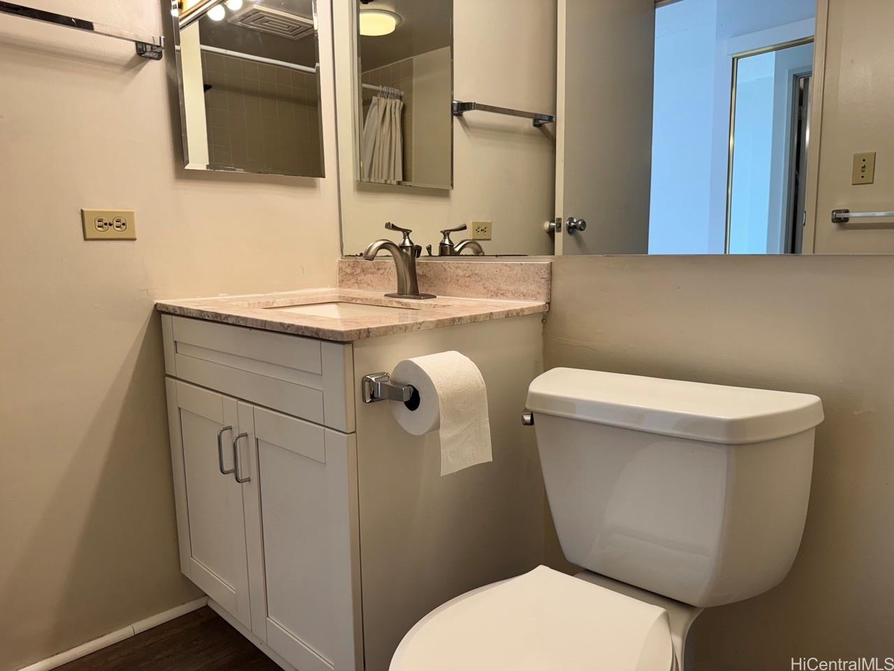 3130 Ala Ilima Street, Unit 22A Honolulu, HI 96818 - Photo 9 of 19 a bathroom with a toilet sink and mirror