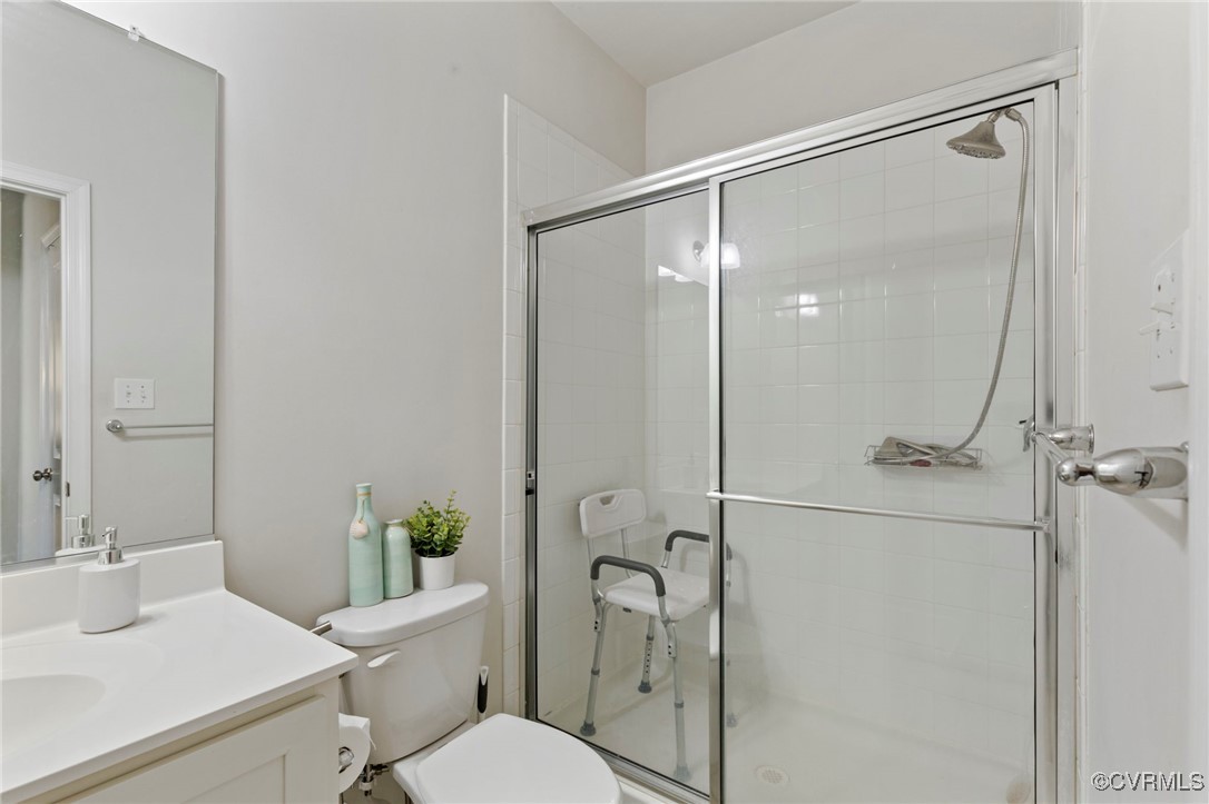 9801 Cravensford Loop Midlothian, VA 23112 - Photo 11 of 49 a bathroom with a shower sink vanity mirror and toilet