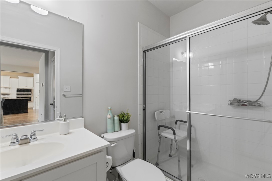 9801 Cravensford Loop Midlothian, VA 23112 - Photo 12 of 49 a bathroom with a sink toilet and shower