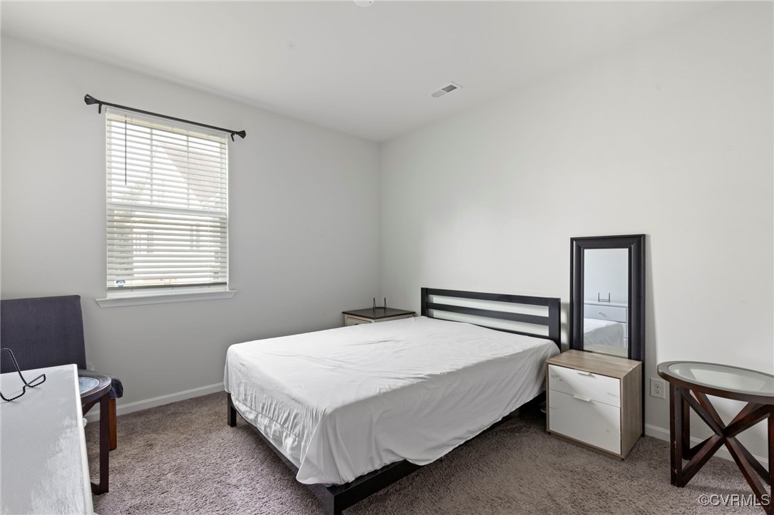 9801 Cravensford Loop Midlothian, VA 23112 - Photo 13 of 49 a bedroom with a bed and a window