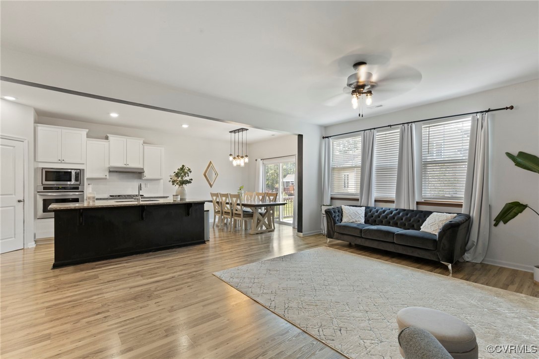 9801 Cravensford Loop Midlothian, VA 23112 - Photo 14 of 49 a living room with furniture kitchen area and a large window