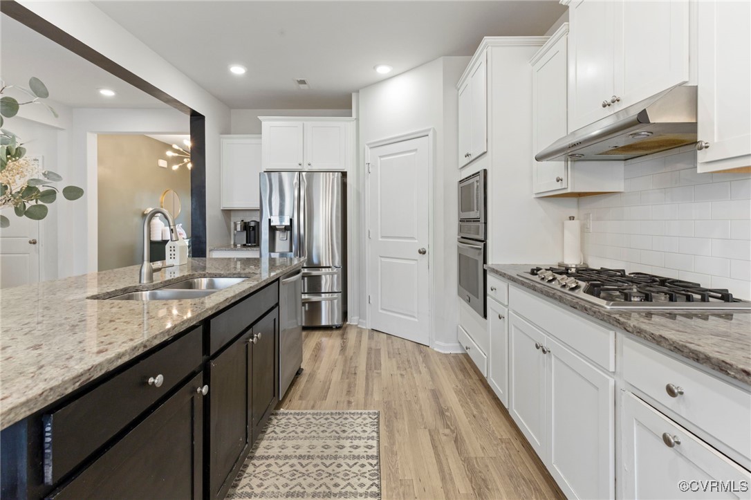9801 Cravensford Loop Midlothian, VA 23112 - Photo 18 of 49 a kitchen with stainless steel appliances a sink stove and refrigerator