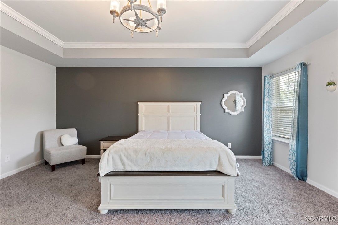 9801 Cravensford Loop Midlothian, VA 23112 - Photo 25 of 49 a bedroom with a bed and a chandelier