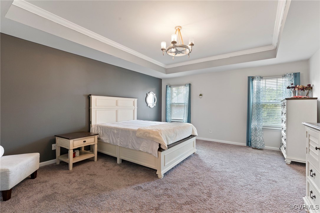 9801 Cravensford Loop Midlothian, VA 23112 - Photo 26 of 49 a spacious bedroom with a bed and a chandelier