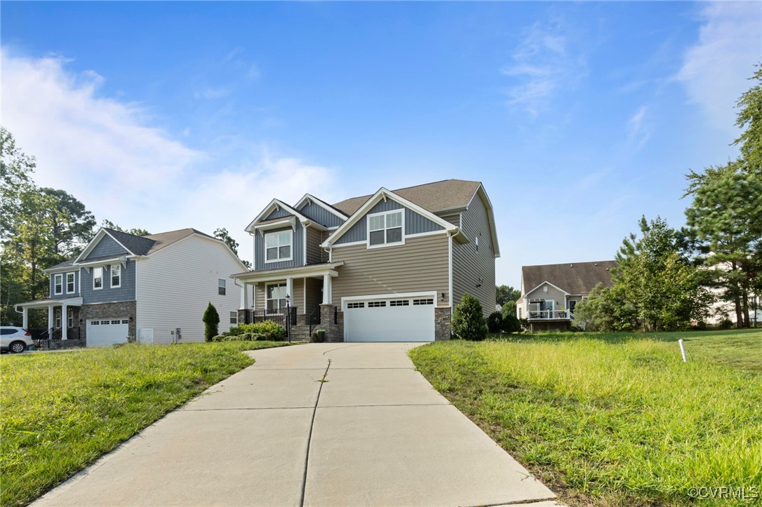 9801 Cravensford Loop Midlothian, VA 23112 - Photo 4 of 49 a front view of a house with a yard