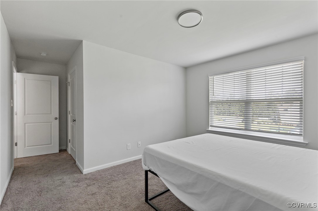9801 Cravensford Loop Midlothian, VA 23112 - Photo 42 of 49 a bedroom with a bed and a window
