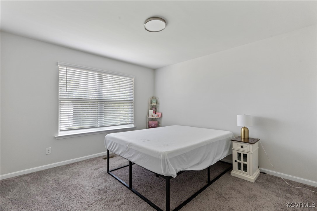 9801 Cravensford Loop Midlothian, VA 23112 - Photo 43 of 49 a bed sitting in a bedroom next to a window