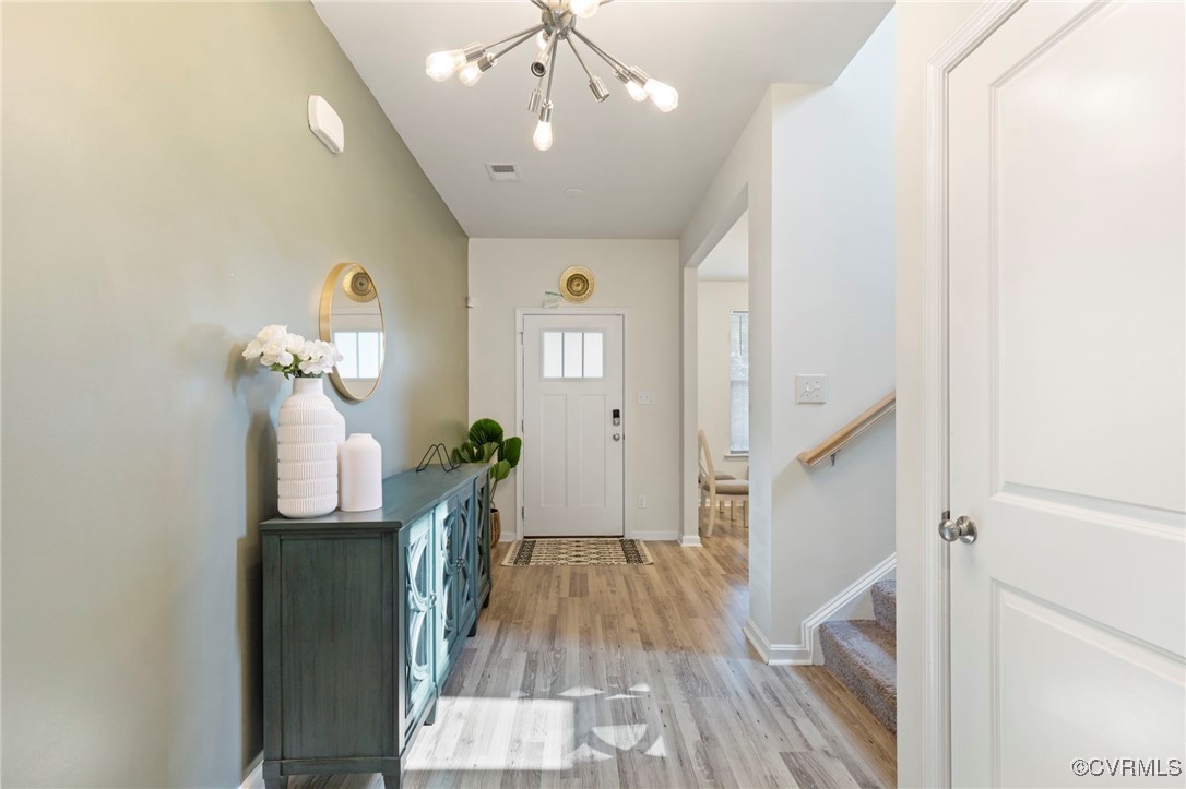 9801 Cravensford Loop Midlothian, VA 23112 - Photo 9 of 49 a view of a hallway with wooden floor and staircase