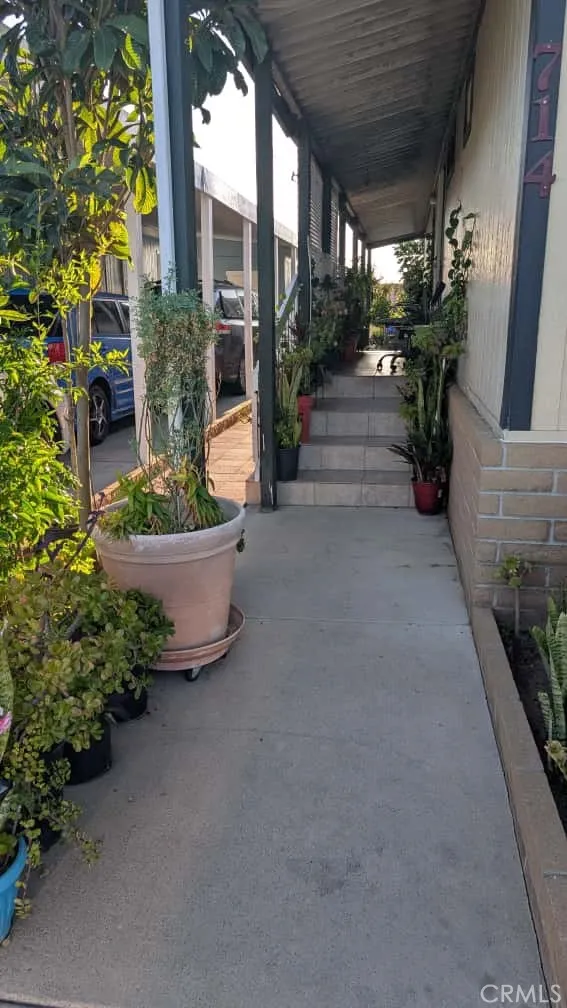 12300 West Lilac Avenue, Unit 714 Santa Ana, CA 92704 - Photo 1 of 22 a view of a house with porch and garden