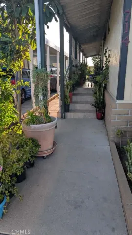 a view of a house with porch and garden