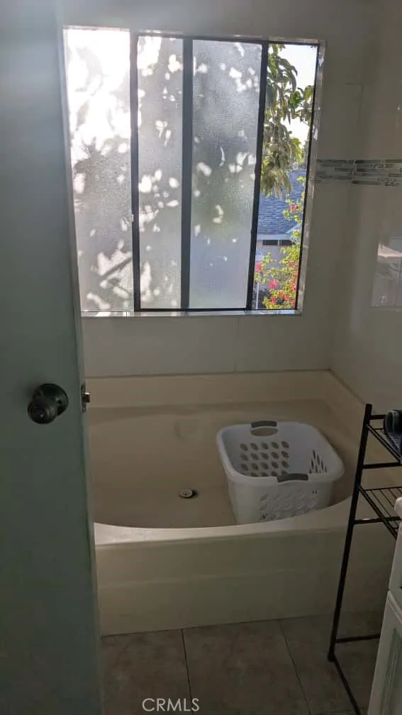 12300 West Lilac Avenue, Unit 714 Santa Ana, CA 92704 - Photo 14 of 22 a bathroom with a bathtub and a window