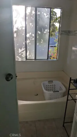 a bedroom with a bed and a mirror