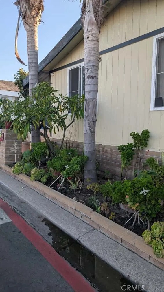 12300 West Lilac Avenue, Unit 714 Santa Ana, CA 92704 - Photo 2 of 22 a front view of a house with garden