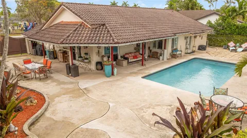 swimming pool view with a seating space