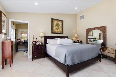 a bedroom with bed and a large mirror