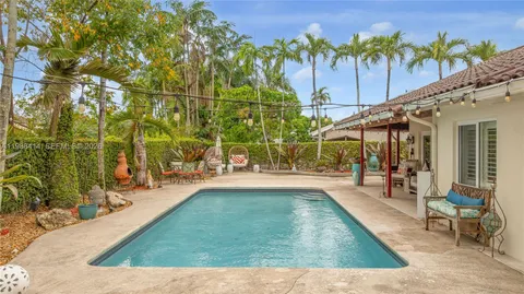 swimming pool view with a seating space