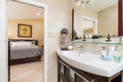 a en suite bathroom with a sink and a mirror