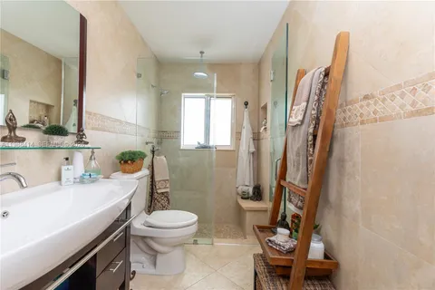 a bathroom with a sink toilet and shower
